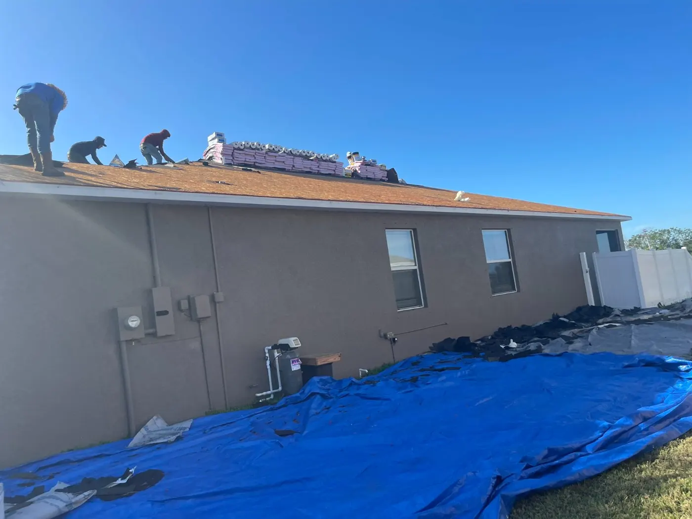 Metro Builders crew installing an emergency roof tarp