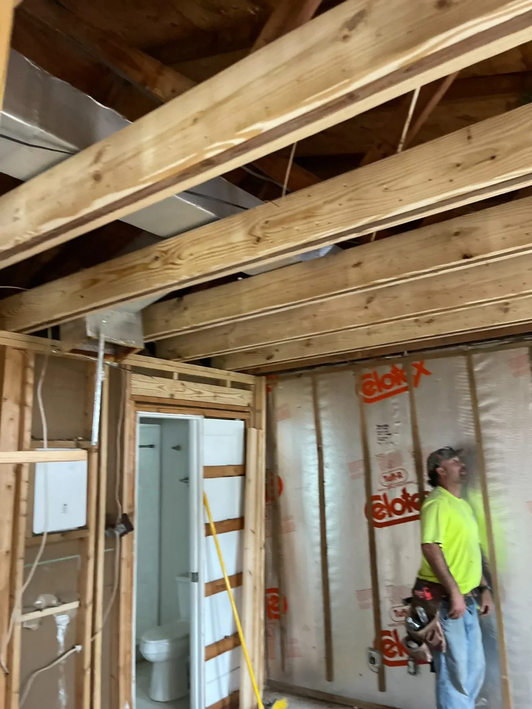 Metro Builders crew member in a room taken down to the studs after water damage
