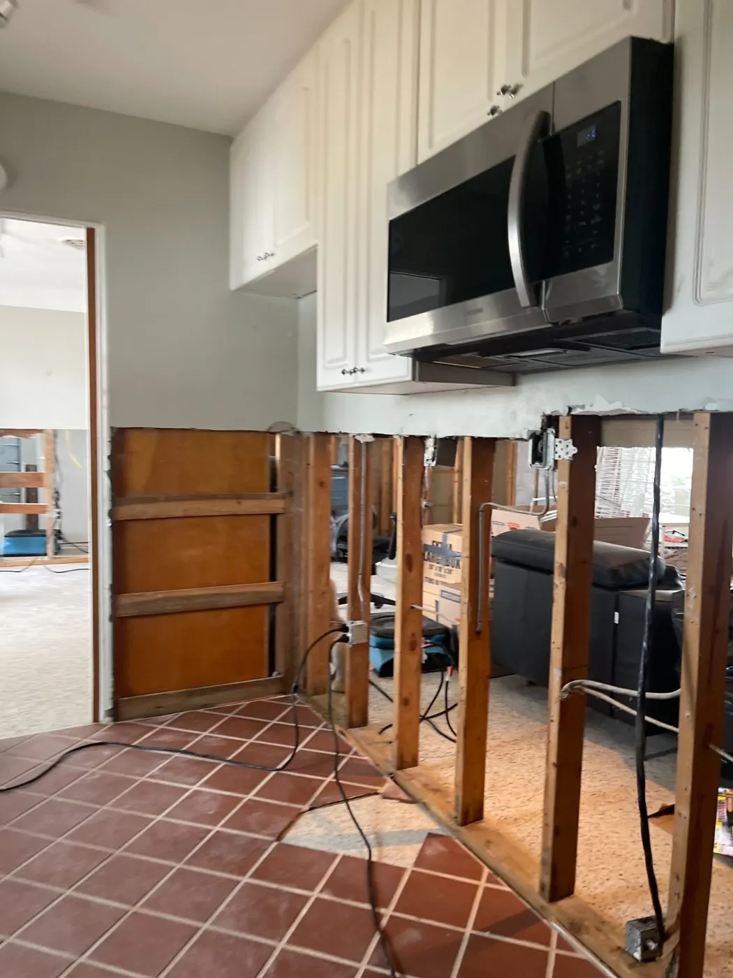 Kitchen with cabinets and drywall removed to the studs during mitigation