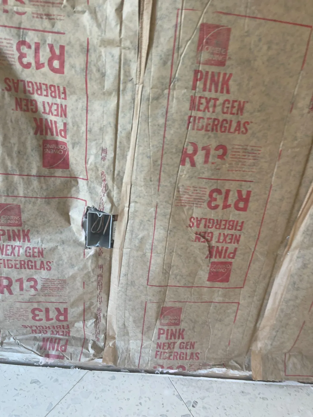 Wet insulation exposed for removal after water damage